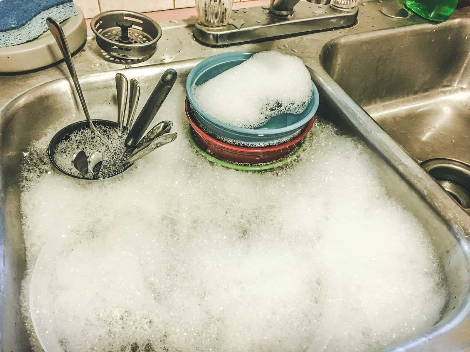 washing dishes in sink